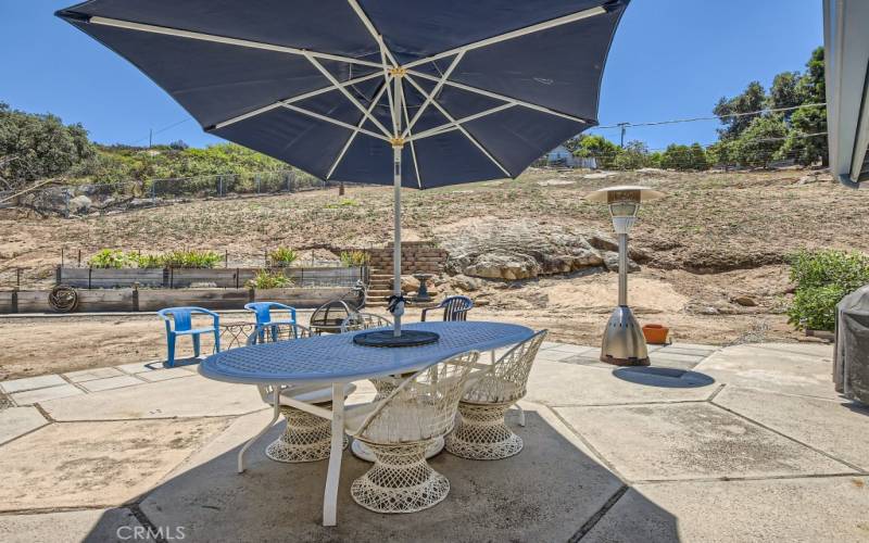 The backyard patio area is welcoming and perfect for cookouts.