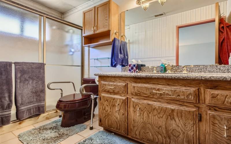 The primary bathroom has granite counter-tops and a real wood vanity.