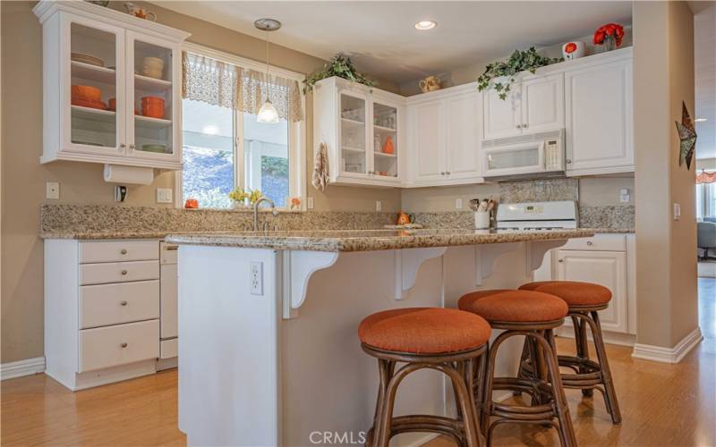Middle granite island has outlet, sitting space, and plenty of room forstorage underneath. Dishes you see here in the cupboards are all staying! They match so nicely too!