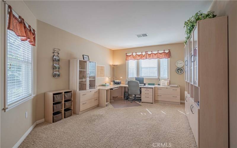 Front Office has a desk and built-ins that all match, and are staying!. Carpeted room. This room is large enough to convert to a bedroom if needed.