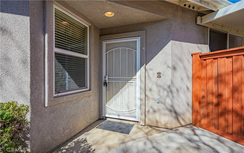 Front entry has a wrought iron screen door, before the door. This allows you to open the door and let the breeze in. Side redwood gate entrance into the back yard patio/bbq areas.