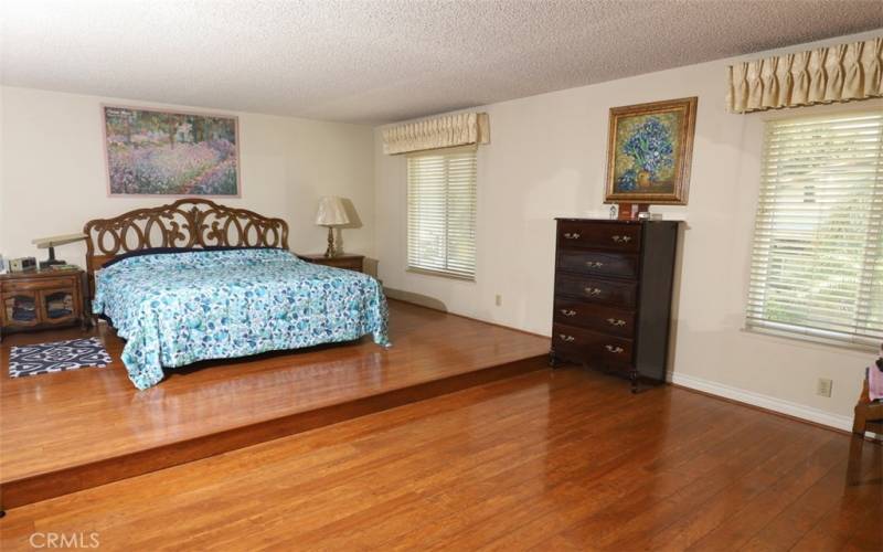 master bedroom has step up pedestal for a bedroom set of any size. newer plantation shutters and hardwood flooring