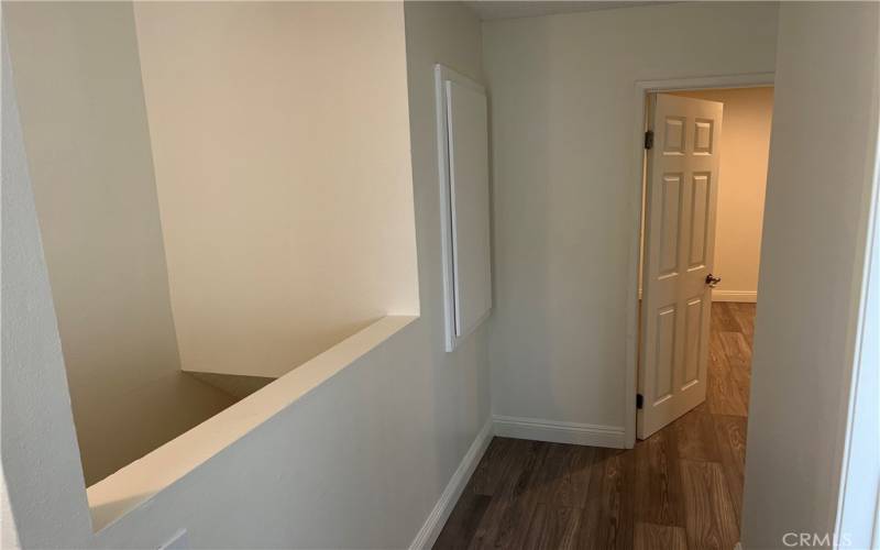 Top of stairs and hall leading to bedrooms and bathroom