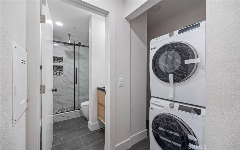Interior laundry area is located upstairs. New stackable washing machine and dryer included.