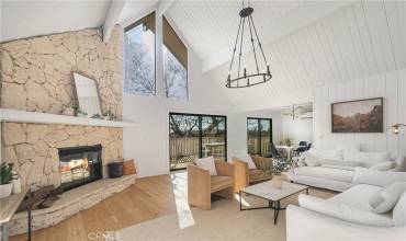 Living room with wood flooring, fireplace and 2 sliding glass doors