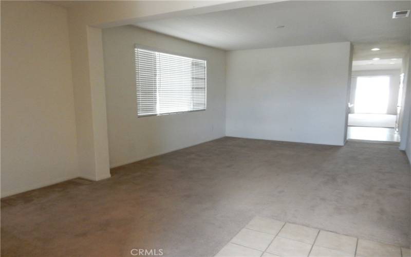 Large living room as you enter the home. Could be retrofitted as a third bedroom and or office if needed.