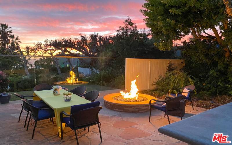 firepit and al fresco dining with outdoor kitchen