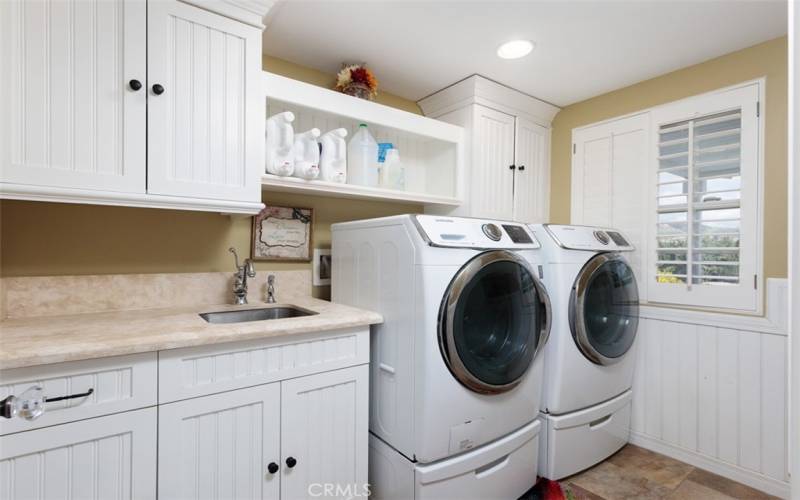 Laundry room located on the main floor with lots of cabinets