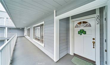 This spacious seaside condo is waiting for you. the screen door (left of the shamrock) rolls up when not in use