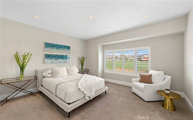 Primary Bedroom with Views of the Golf Course and Access to the Deck