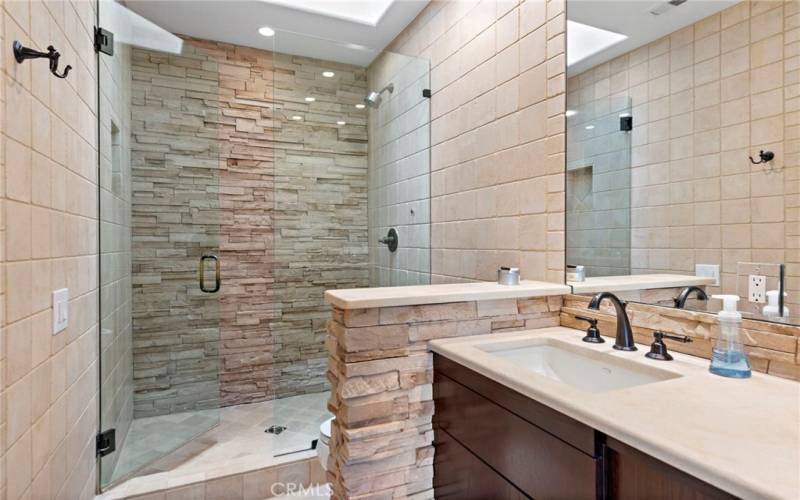 Primary Bathroom Shower Accented with a Skylight
