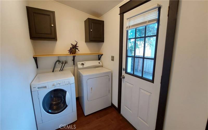 Laundry room with cabs, shelf and pole. W/D stays