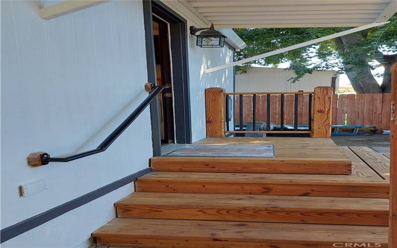 Sturdy safety rail adds to the custom redwood steps and back door landing
