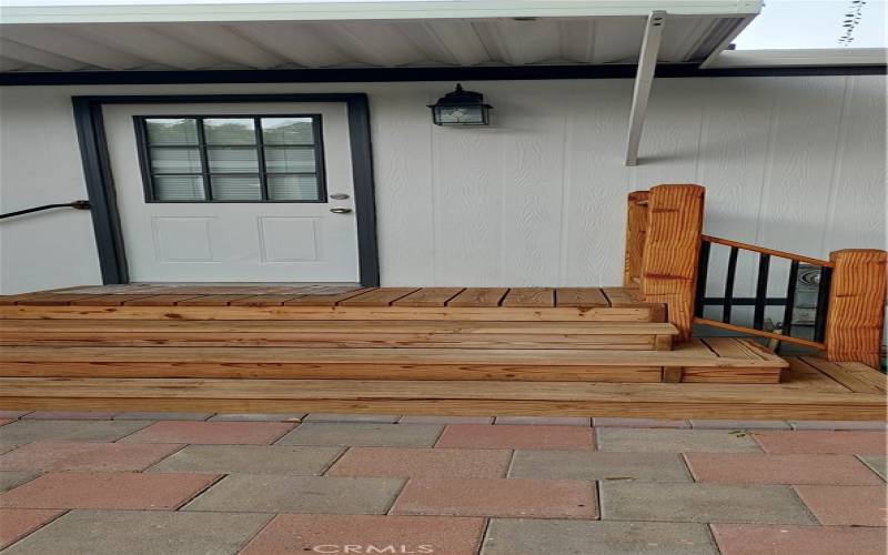Sturdy custom wood steps and deck gives easy access to laundry room and kitchen.