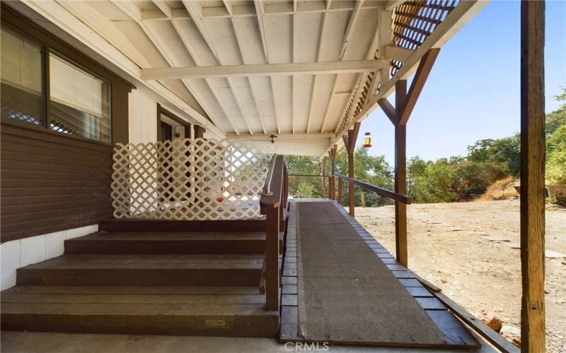 Stairs and ramp access front door from carport.