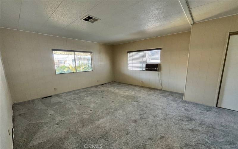 Primary bedroom with extra window cooler (house has central A/C)