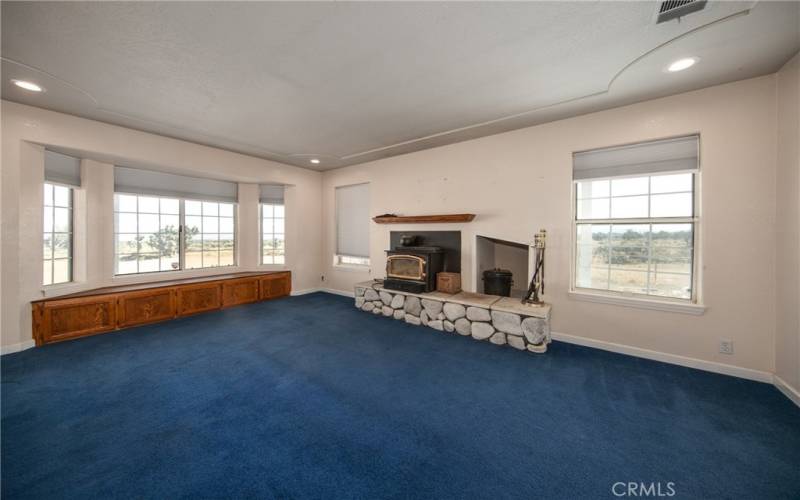 Living room with fireplace and wood storage