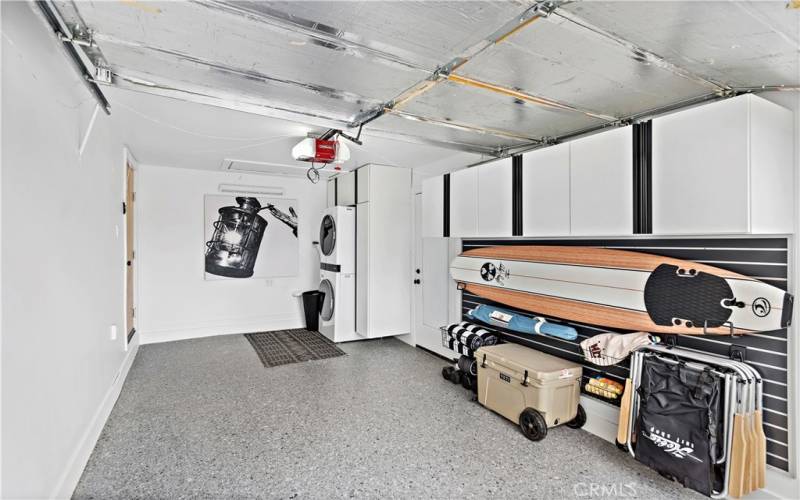 Single car garage with LG stackable washer and dryer and beach toys