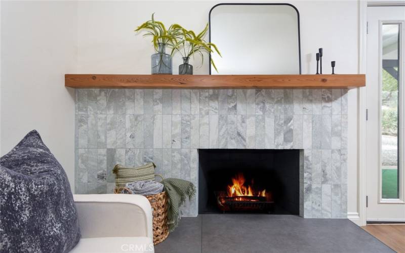 Remodeled fireplace with marble tile and cedar beam mantle