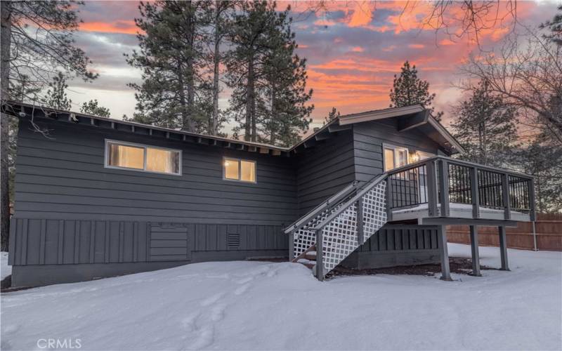 Back of home with deck to the laundry/mud room.