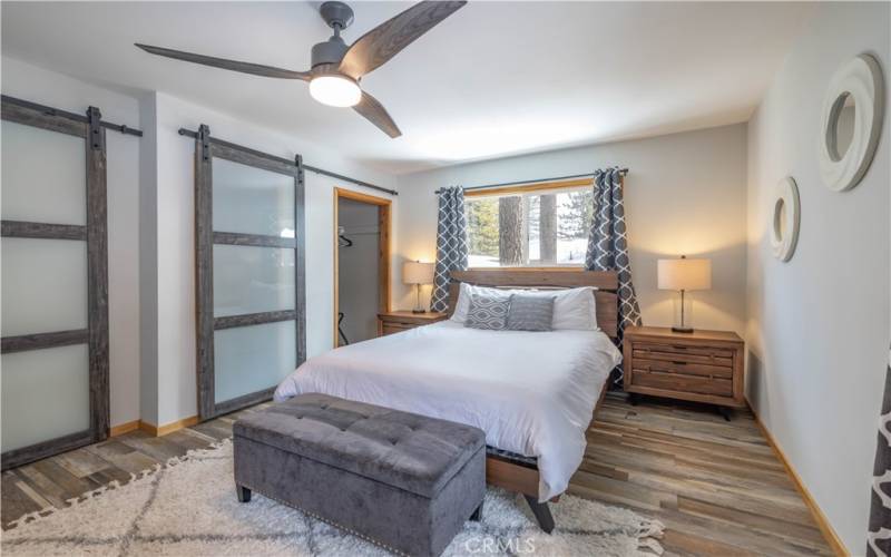 Master bedroom with updated glass barn doors.