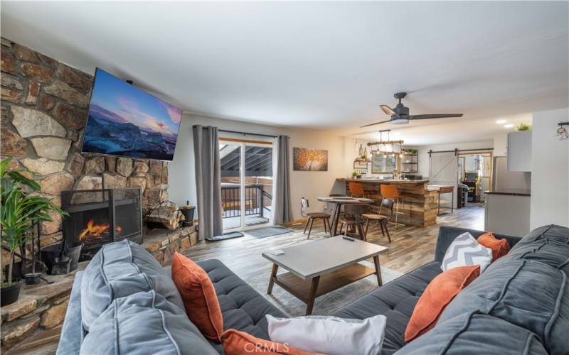 Open living space with gorgeous stone fireplace.