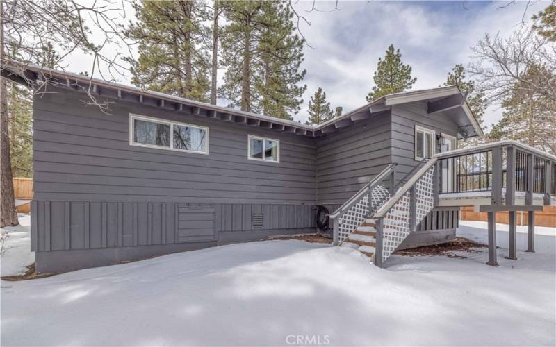 Back of home with deck to laundry/mud room.