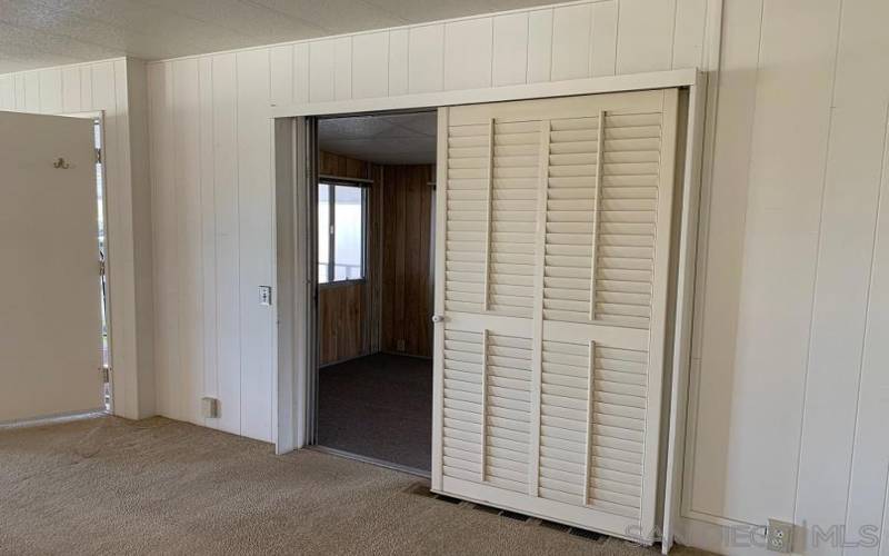 OPEN Louvered Door covering entry to Sun Room