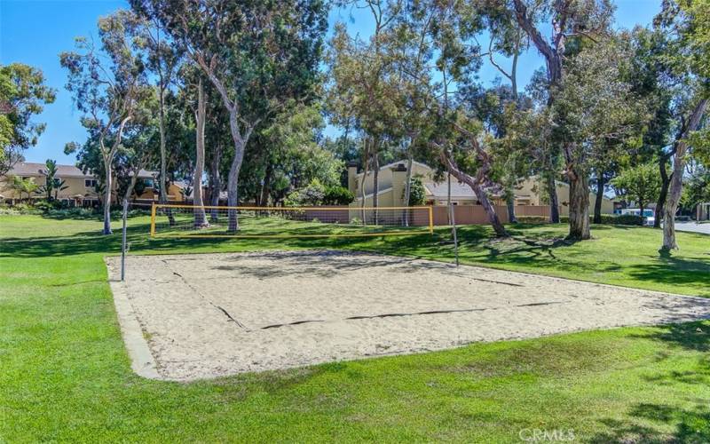 Sand volleyball court next to clubhouse.