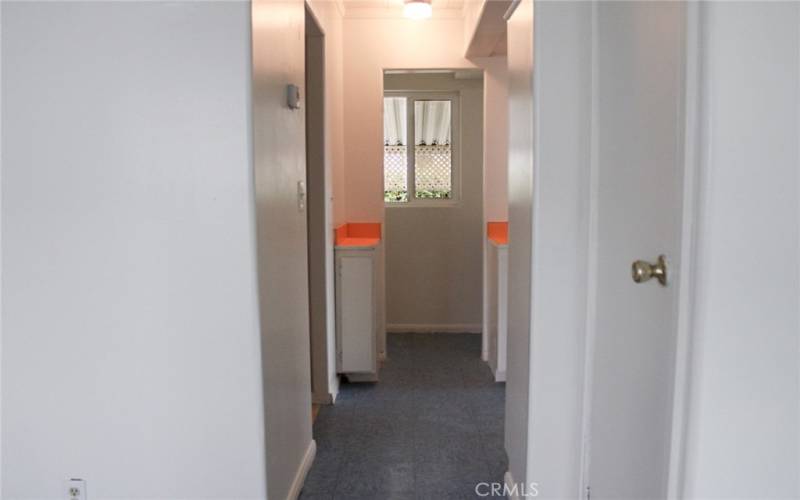 Hallway to the pantry area and kitchen and laundry area