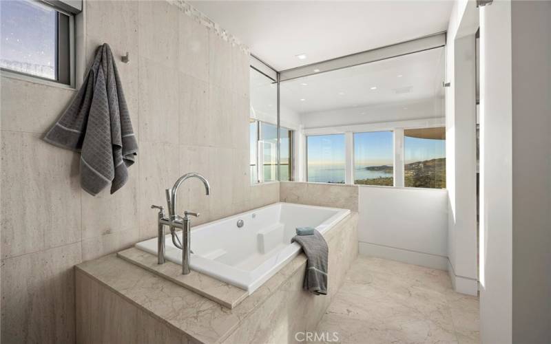 Master suite with soaking tub viewing the ocean