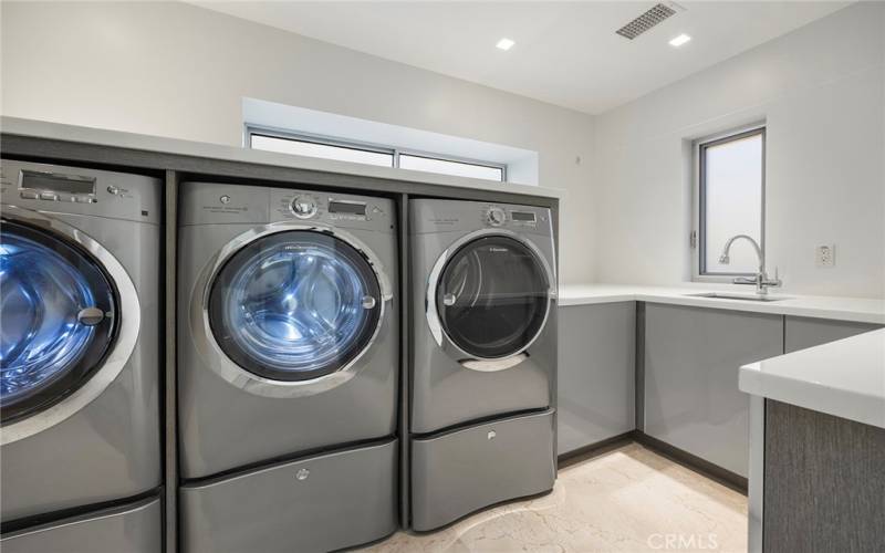 Walk in laundry room with cabinet and storage room