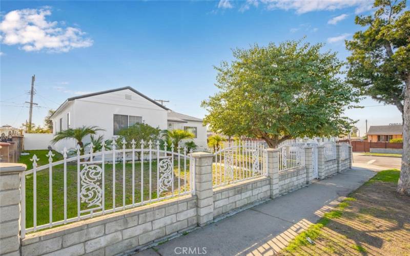 block wall with wrought iron fencing surrounds the entire property