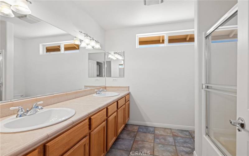 Hall bath with double vanity situated between bedroom 1 and 2.