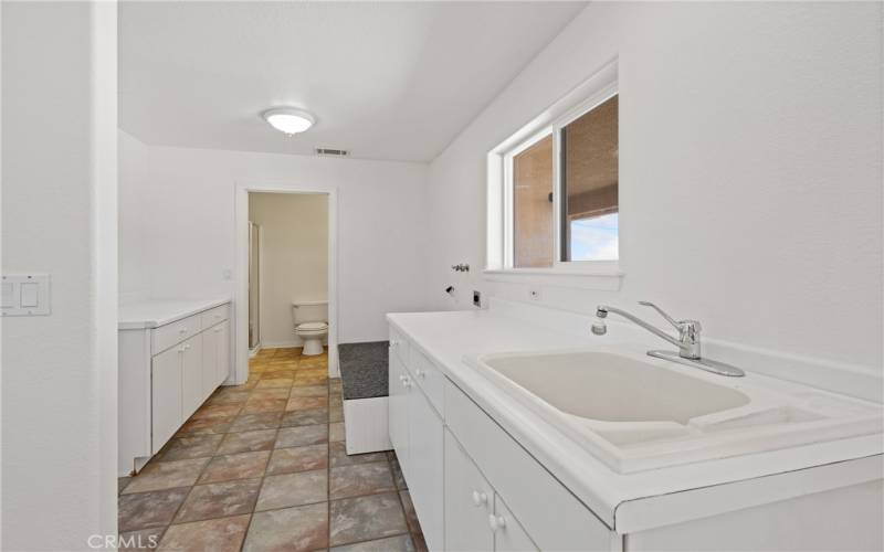 Laundry room with tons of storage and utility sink.