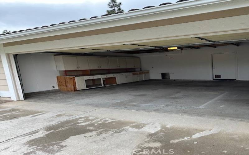 2 car remote controlled garage has built-in cupboards, door that leads into the kitchen and overhead storage space.
