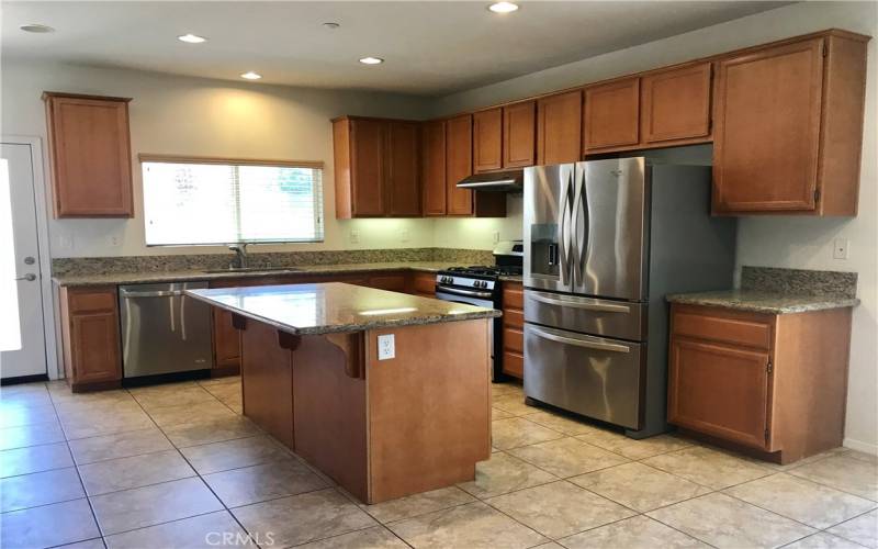 Spacious kitchen with newer stainless steel appliances, granite countertops, large island and plenty of cabinets.