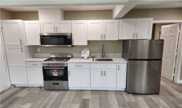 Full SS appliance set makes a great kitchen! Adding a butcher block and tall dining table will make this an amazing place to make dinner for a few friends or famly!