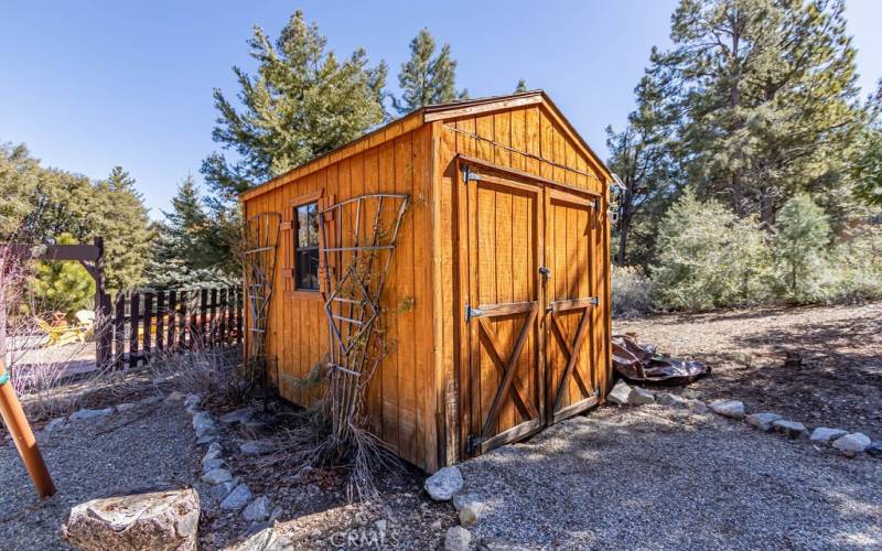 The attractive shed offers room for your golf cart and tools.