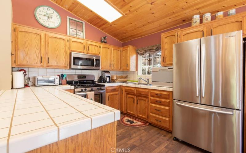 The well-appointed kitchen has stainless steel appliances and plenty of counter space for food preparation and serving space.