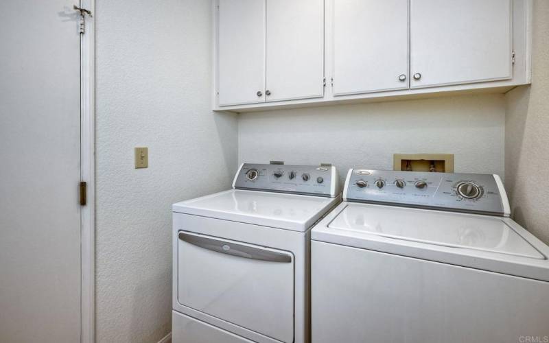 Laundry Room with a large sink and storage cabinets