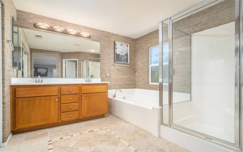 Master bath with dual sink vanity, large soaking tub, & separate walk-in shower