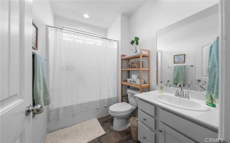 Roomy guest bathroom with tub and shower