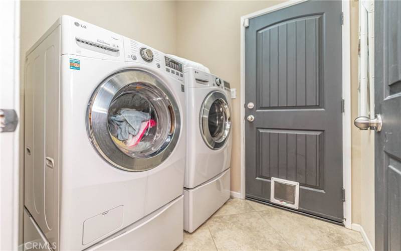 Laundry room with access to garage.