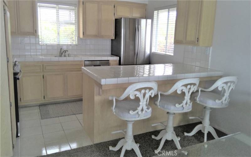 ENTERTAINING KITCHEN WITH BREAKFAST BAR/COUNTER ISLAND. MICRO WAVE, RANGE,  REFRIGERATOR, AND DISHWASHER INCLUDED.