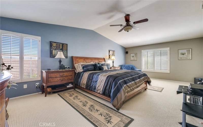 Primary bedroom, includes a full bathroom with walk-in closet, bath tub, separate walk-in shower, double vanity area and sinks with storage underneath.