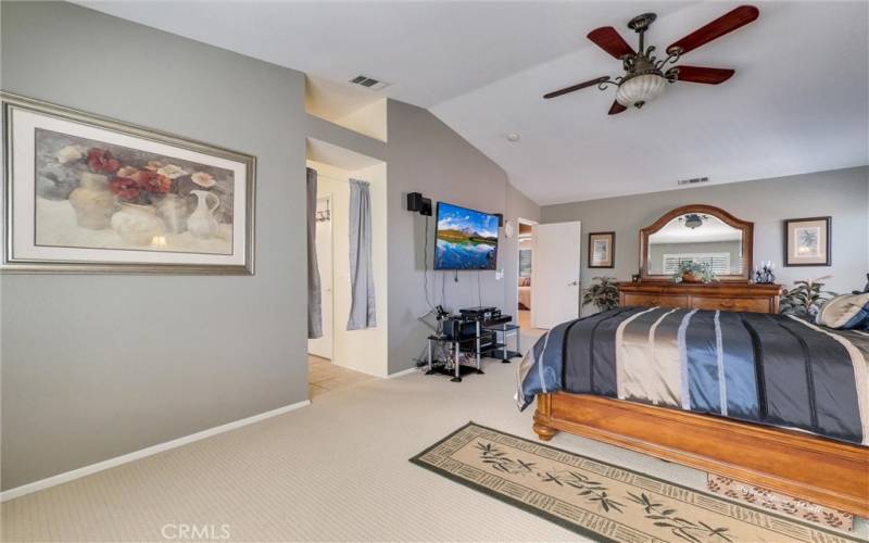 Primary bedroom, includes a full bathroom with walk-in closet, bath tub, separate walk-in shower, double vanity area and sinks with storage underneath.