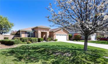 Lushly landscaped front yard with mature tree and oversized driveway!