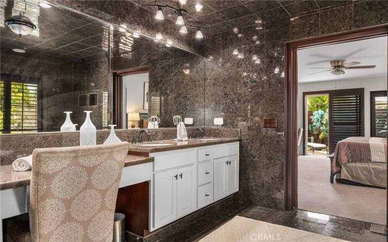 The expanded vanity with smooth granite counters offers seating too, giving everyone enough space to get ready anytime!