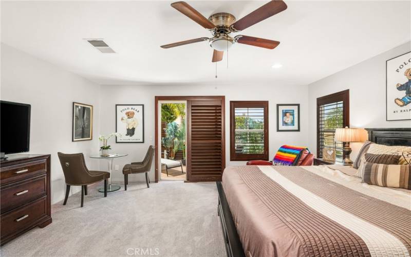 Spacious primary suite with ceiling fan.